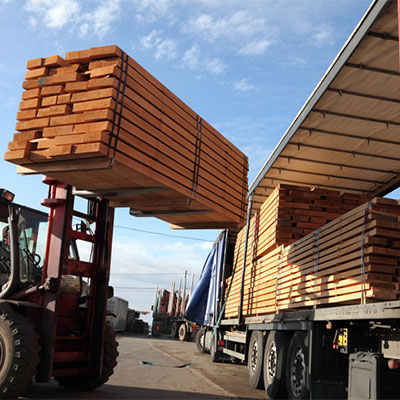mini forklift carrying stacks of wood panels
